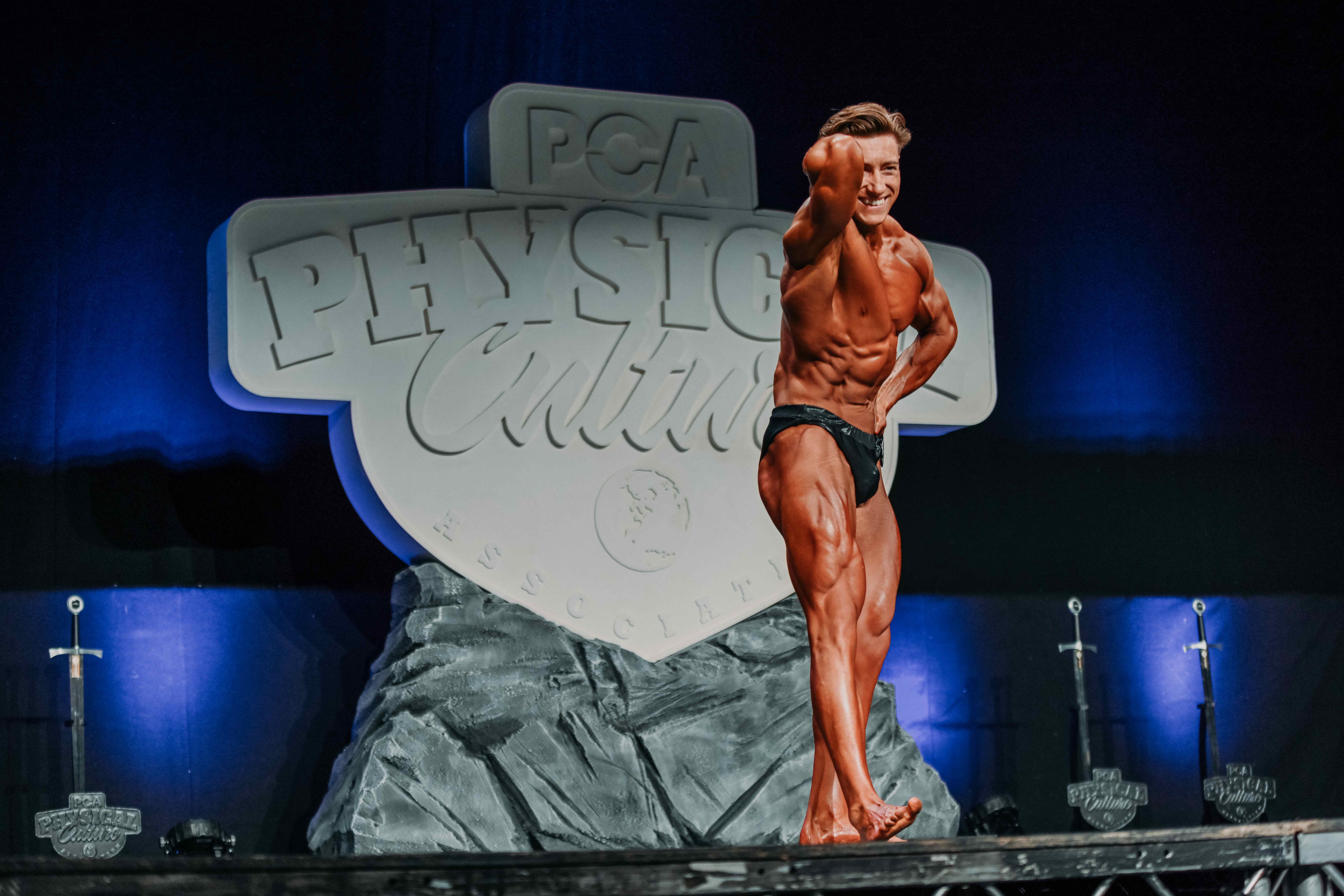 Storey Strength coach on stage at PCA Physical Culture competition